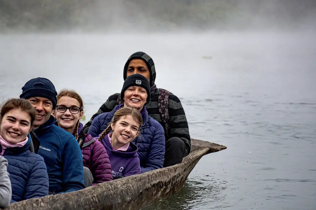 family enjoying on a boat in lake of Nepal