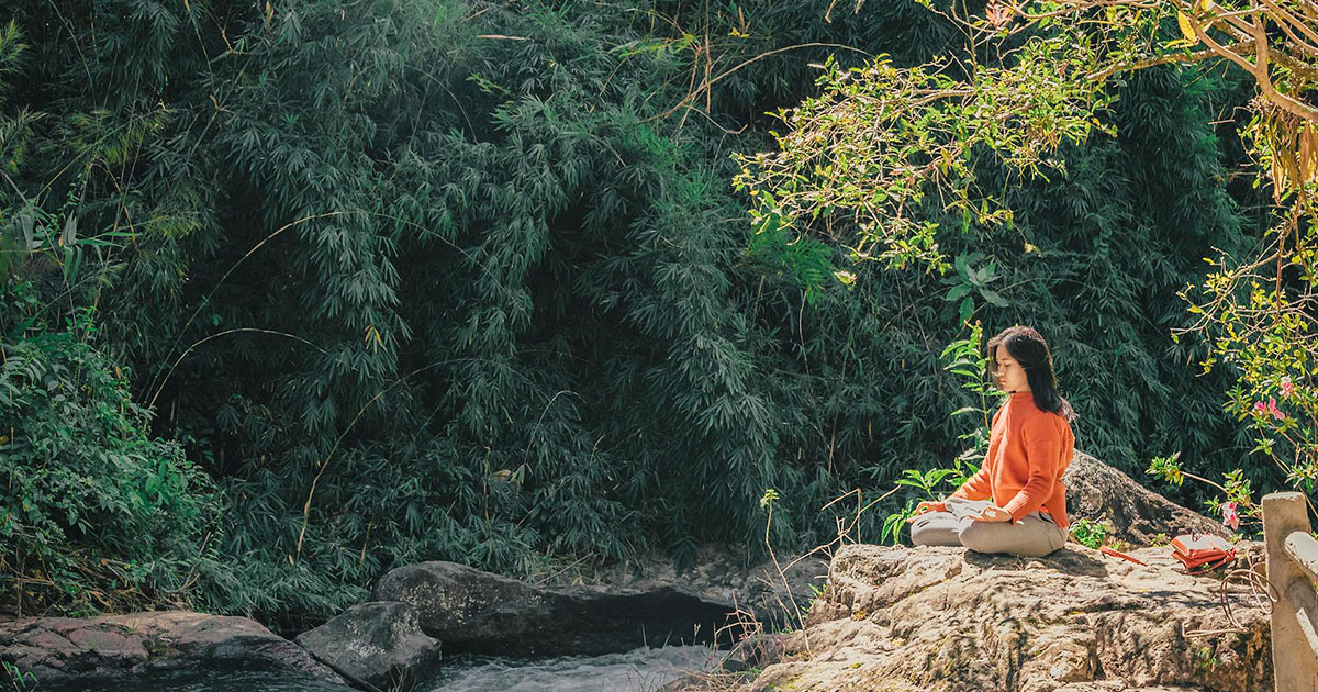 Women meditating in nature.