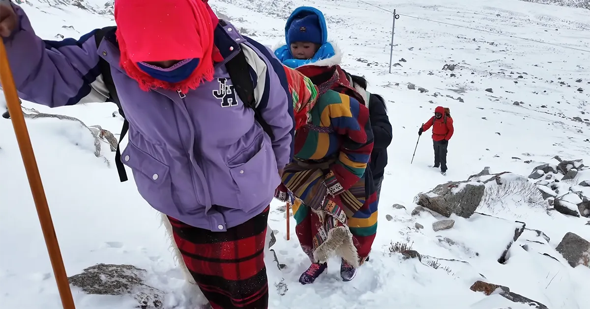 Mother carrying children on Kailash Winter Trek