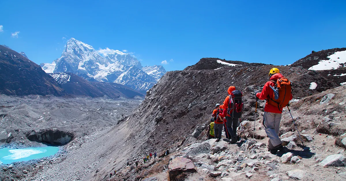 Trekker walking down the rough terrain