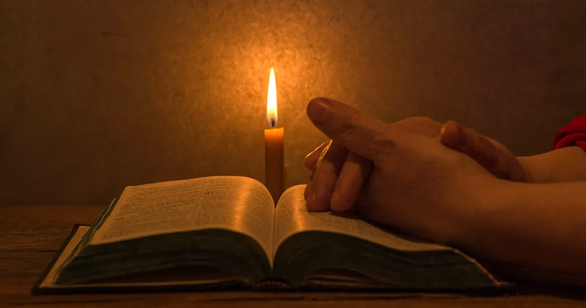Student reading with candle light